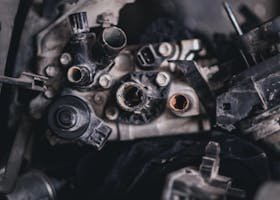 Detailed view of various disassembled engine components in an auto repair shop.